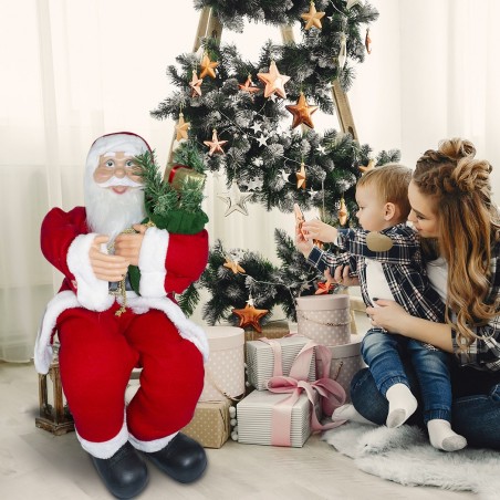 144059 Papá Noel sentado en silla 90 cm con bolsa de regalo y sonidos navideños
